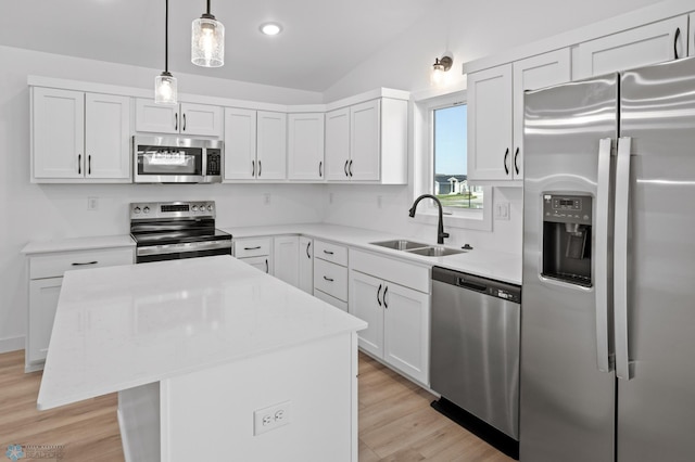 7279 26th St S, Fargo, ND 58104 - kitchen with stainless steel appliances, a sink, lofted ceiling, a center island, and white cabinets