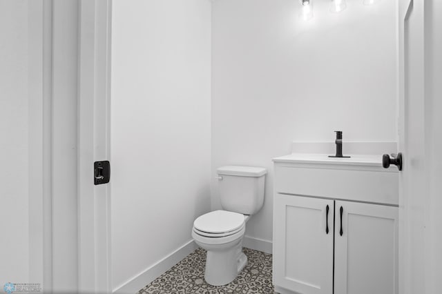 7279 26th St S, Fargo, ND 58104 - bathroom with toilet, baseboards, and vanity