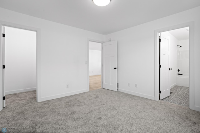 7279 26th St S, Fargo, ND 58104 - unfurnished bedroom with carpet, baseboards, a spacious closet, and ensuite bathroom