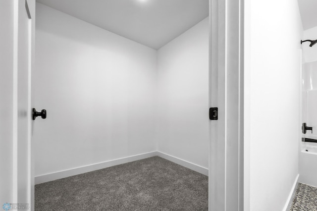 7279 26th St S, Fargo, ND 58104 - bathroom featuring baseboards, carpet floors, and vaulted ceiling