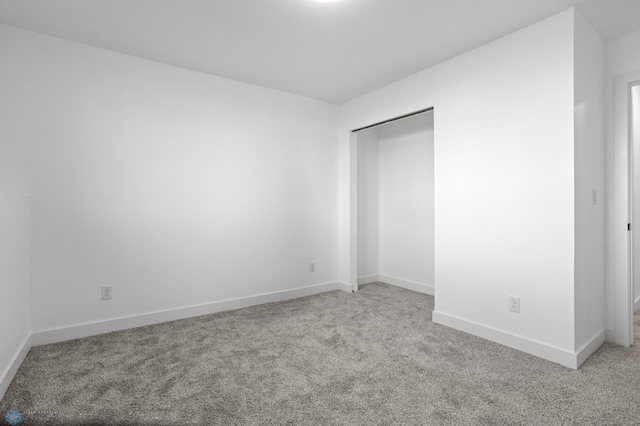7279 26th St S, Fargo, ND 58104 - unfurnished bedroom with light colored carpet, baseboards, and a closet