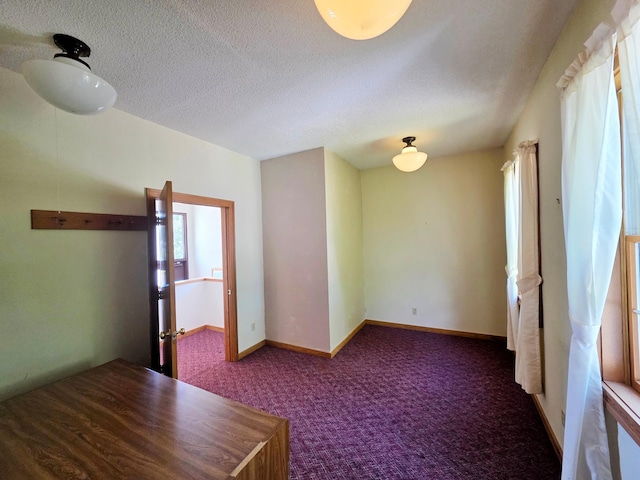 642 6th Ave, Calumet, MN 55716 - carpeted spare room featuring healthy amount of natural light, a textured ceiling, and baseboards