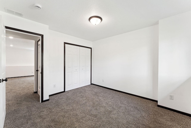 1094 7th St E, Saint Paul, MN 55106 - unfurnished bedroom with carpet floors, baseboards, and a closet