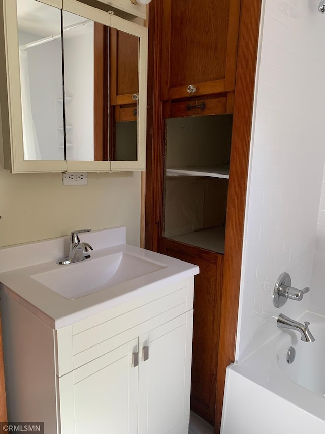 full bath featuring vanity and bathtub / shower combination