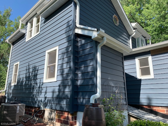 view of side of home featuring central AC unit