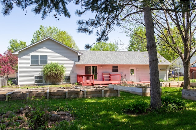 1377 Parkview Dr, New Richmond, WI 54017 - rear view of property featuring a garden, a lawn, a wooden deck, and a shingled roof