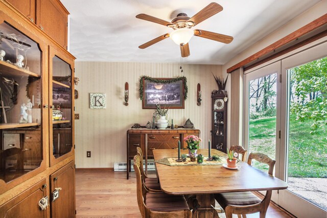 26163 170th St, New Richland, MN 56072 - dining space featuring light wood finished floors, ceiling fan, baseboards, and a baseboard radiator