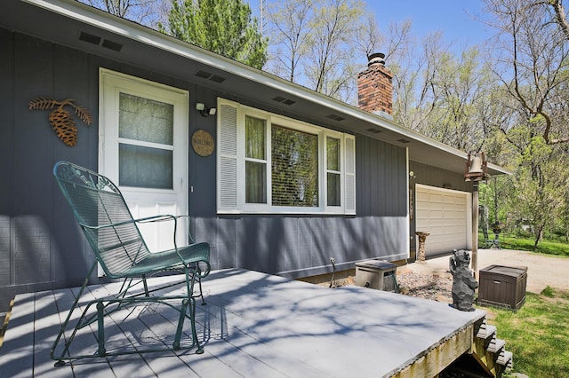 26163 170th St, New Richland, MN 56072 - view of property exterior featuring a garage, a chimney, and driveway