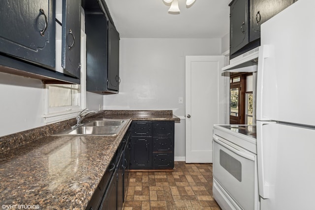 kitchen featuring white appliances, a sink, under cabinet range hood, dark countertops, and brick patterned flooring