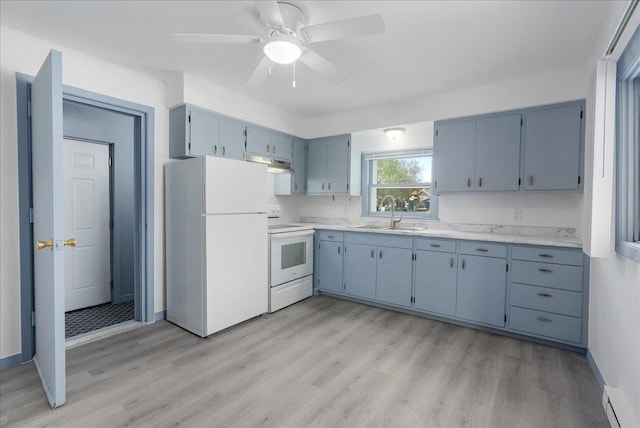 231 High St, New Richmond, WI 54017 - kitchen featuring white appliances, a sink, light countertops, light wood-type flooring, and baseboard heating
