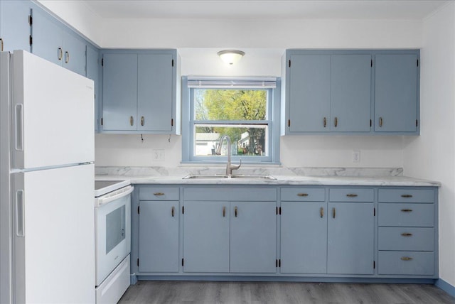 231 High St, New Richmond, WI 54017 - kitchen featuring white appliances, a sink, light countertops, light wood finished floors, and crown molding