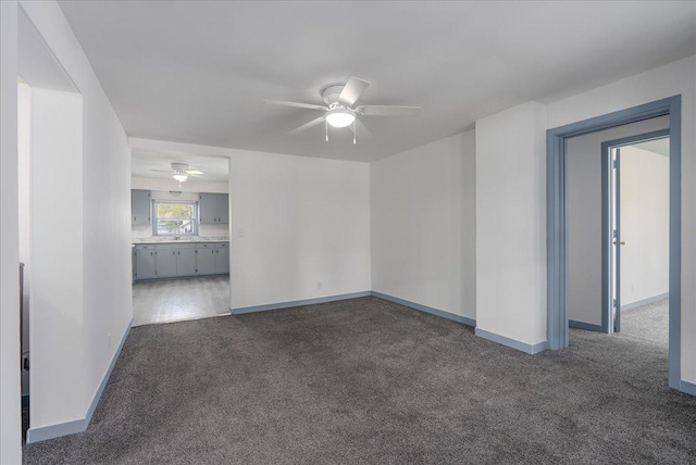 231 High St, New Richmond, WI 54017 - unfurnished living room featuring ceiling fan, carpet, and baseboards
