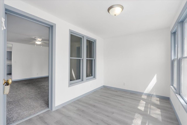 231 High St, New Richmond, WI 54017 - empty room featuring wood finished floors, a ceiling fan, and baseboards