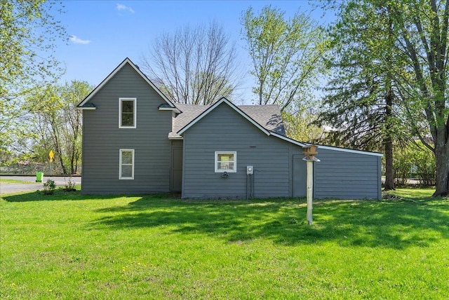 231 High St, New Richmond, WI 54017 - rear view of house featuring a yard and a shingled roof