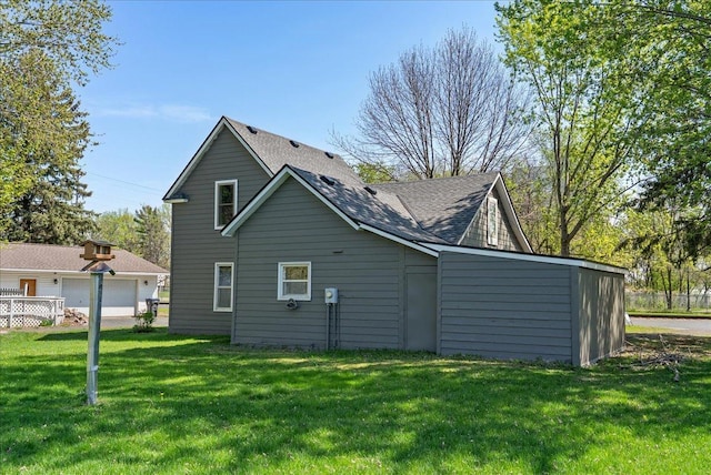 231 High St, New Richmond, WI 54017 - back of house featuring a yard and roof with shingles