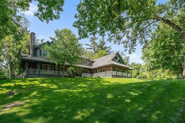 2 Pleasant Lake Rd, North Oaks, MN 55127 - back of house with a yard, a chimney, and covered porch