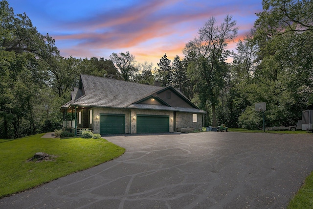 2 Pleasant Lake Rd, North Oaks, MN 55127 - view of front of house featuring an attached garage, a front yard, asphalt driveway, stone siding, and a chimney