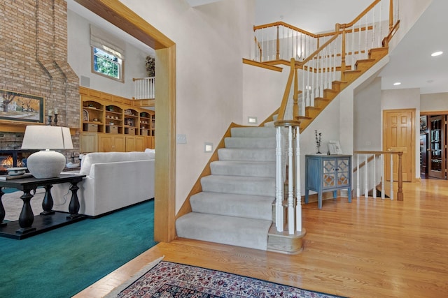 2 Pleasant Lake Rd, North Oaks, MN 55127 - stairs featuring a towering ceiling, wood finished floors, recessed lighting, and built in shelves