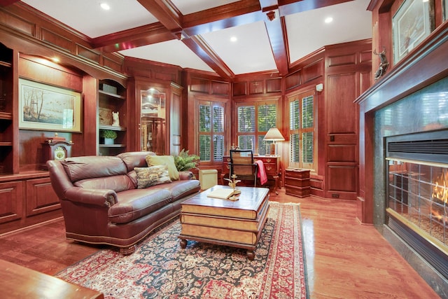 2 Pleasant Lake Rd, North Oaks, MN 55127 - living room featuring a glass covered fireplace, light wood-type flooring, beamed ceiling, coffered ceiling, and wooden walls