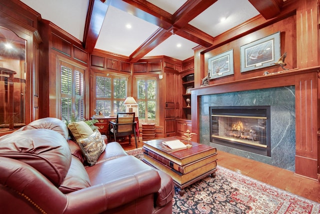 2 Pleasant Lake Rd, North Oaks, MN 55127 - living area featuring a fireplace, wood finished floors, beam ceiling, built in shelves, and a decorative wall