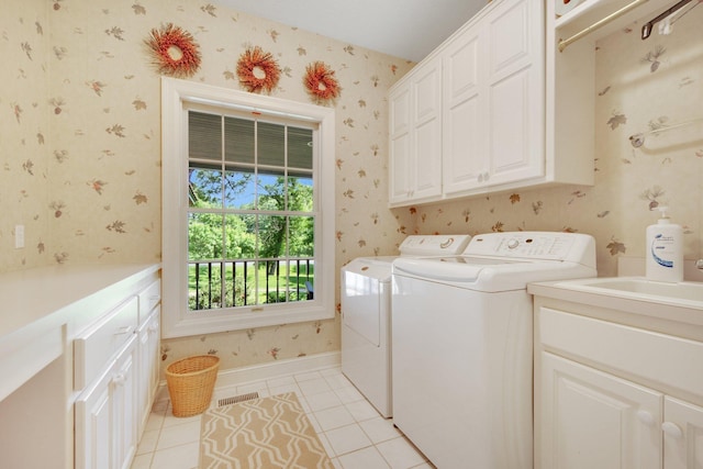 2 Pleasant Lake Rd, North Oaks, MN 55127 - washroom featuring wallpapered walls, cabinet space, washer and clothes dryer, and light tile patterned floors