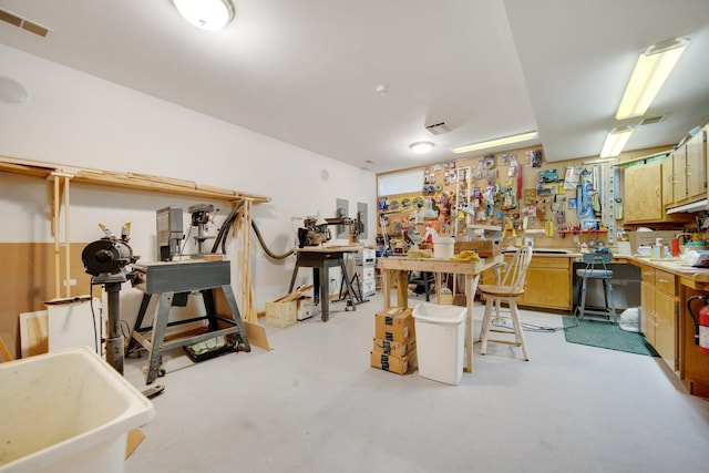 2 Pleasant Lake Rd, North Oaks, MN 55127 - miscellaneous room with a workshop area and concrete flooring