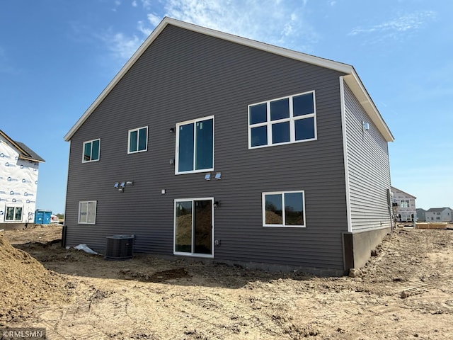 back of property featuring central AC