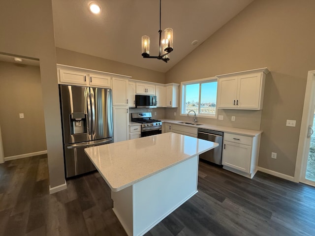 kitchen with stainless steel appliances, dark wood-type flooring, white cabinets, baseboards, and high vaulted ceiling