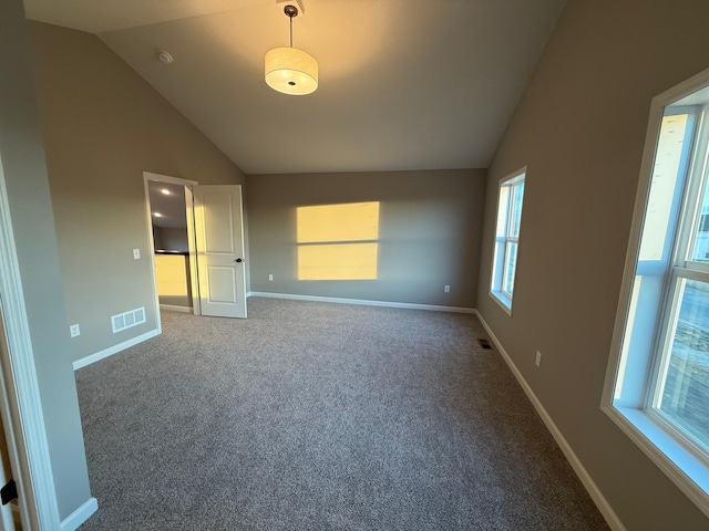 unfurnished bedroom with vaulted ceiling, carpet, and baseboards