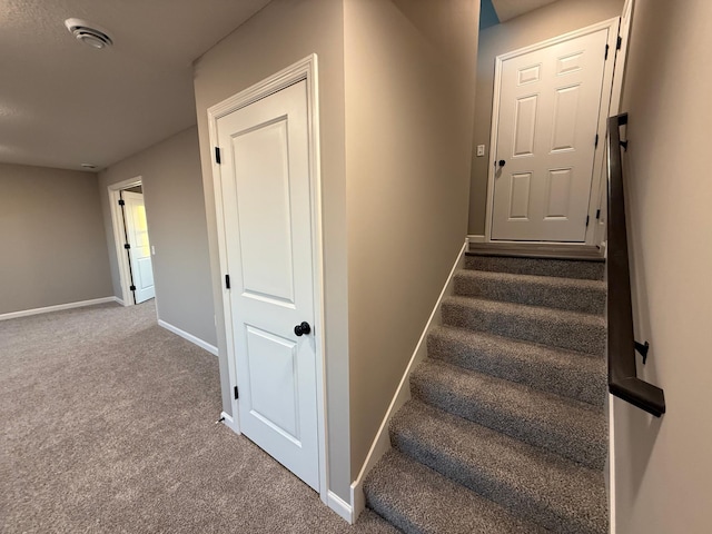 staircase with carpet floors and baseboards