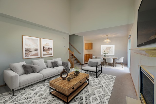 6147 Tahoe Cir Unit A, Woodbury, MN 55125 - living room featuring stairway, a high ceiling, a fireplace, light colored carpet, and a chandelier