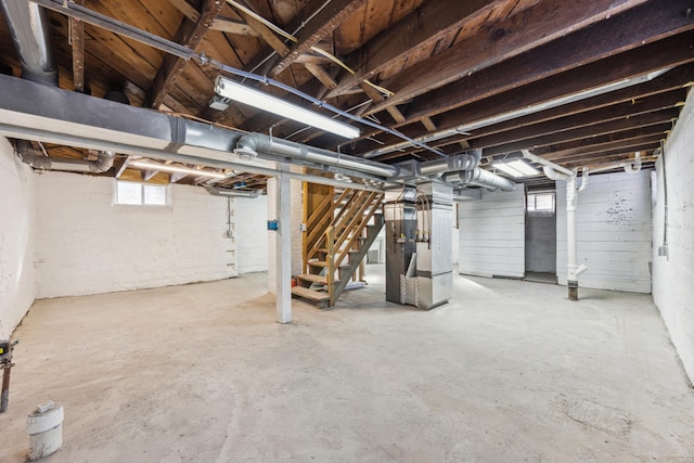 193 Griggs St N, Saint Paul, MN 55104 - basement featuring heating unit, stairs, and plenty of natural light