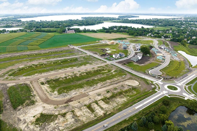aerial view of property and surrounding area with a nearby body of water