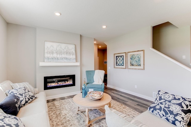 205 Snowdrop Trl, Waconia, MN 55387 - living room featuring wood finished floors, a glass covered fireplace, and recessed lighting