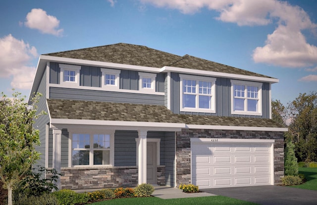 205 Snowdrop Trl, Waconia, MN 55387 - view of front of house with stone siding, a garage, driveway, and board and batten siding
