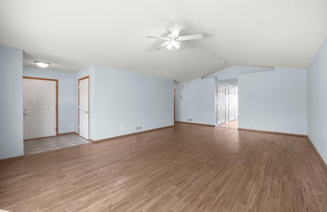 unfurnished living room with ceiling fan, light wood-style flooring, lofted ceiling, and baseboards