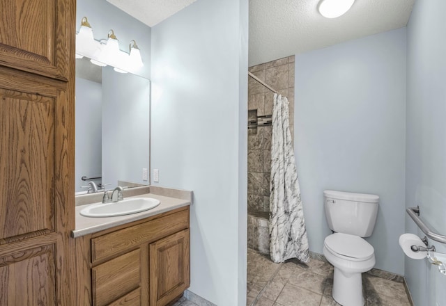 bathroom with toilet, a tile shower, a textured ceiling, vanity, and tile patterned flooring