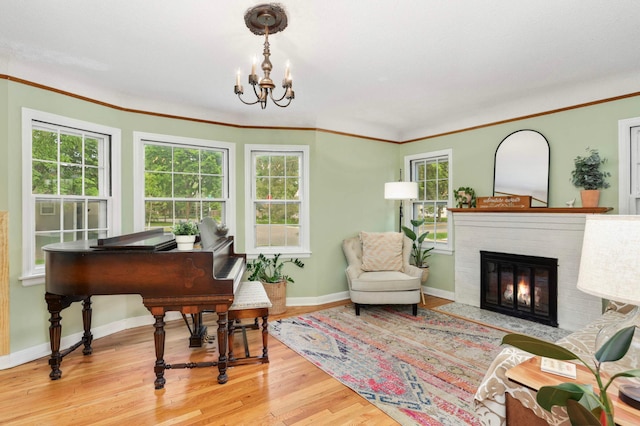 3338 Brownlow Ave, Saint Louis Park, MN 55426 - living area with wood finished floors, baseboards, a brick fireplace, a chandelier, and ornamental molding