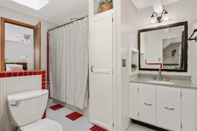 3338 Brownlow Ave, Saint Louis Park, MN 55426 - bathroom featuring vanity, toilet, tile patterned flooring, curtained shower, and a textured ceiling