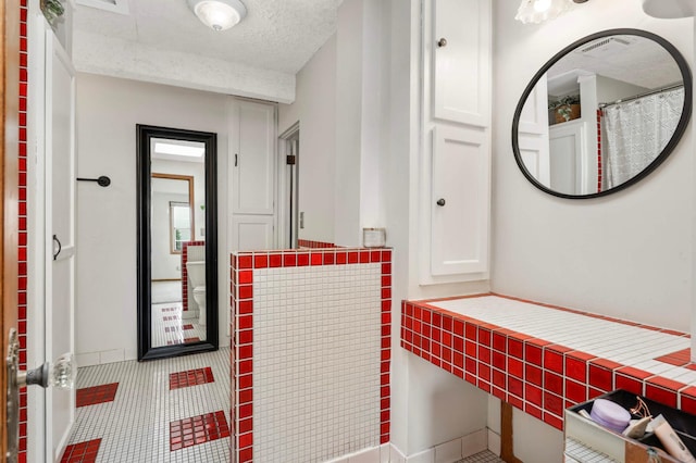 3338 Brownlow Ave, Saint Louis Park, MN 55426 - bathroom featuring tile patterned floors and a textured ceiling