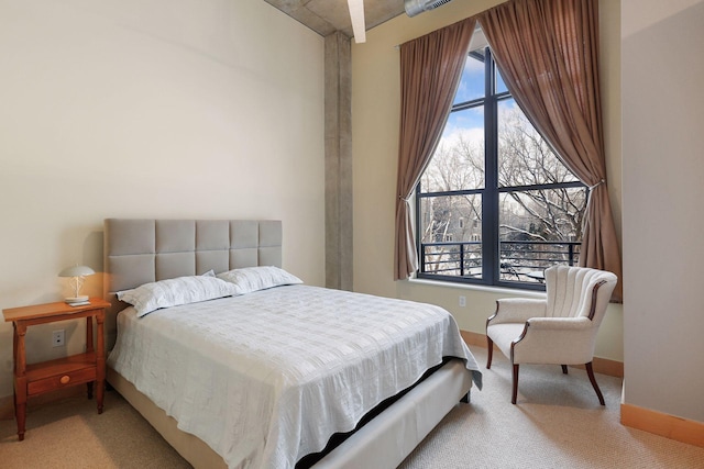 bedroom with carpet, multiple windows, and baseboards