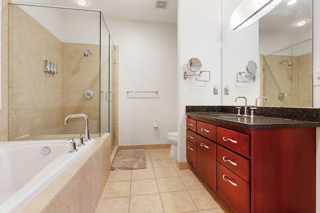 full bathroom featuring toilet, a stall shower, vanity, a garden tub, and tile patterned floors