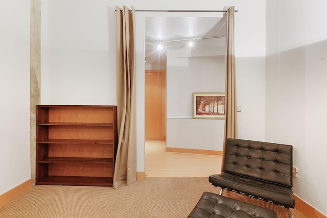 living area with carpet and baseboards