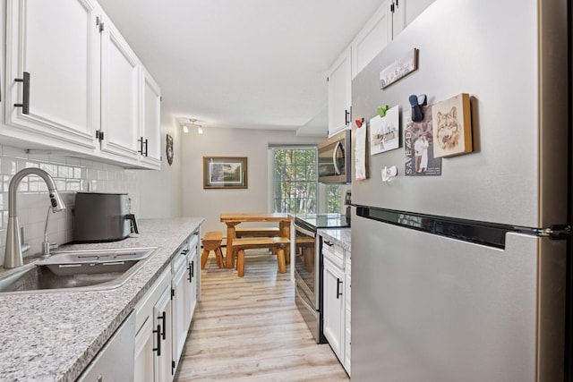 4430 Cedar Lake Rd S Unit 6, Saint Louis Park, MN 55416 - kitchen with stainless steel appliances, a sink, and white cabinets