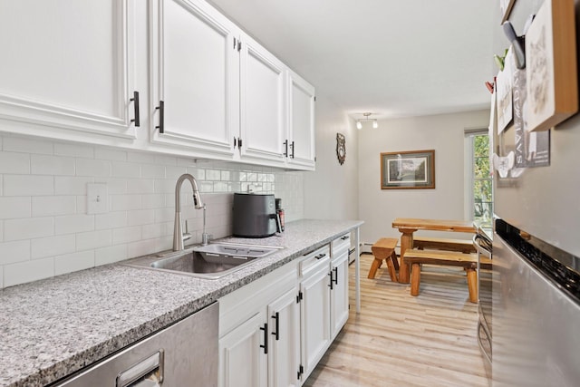 4430 Cedar Lake Rd S Unit 6, Saint Louis Park, MN 55416 - kitchen featuring freestanding refrigerator, a sink, light wood-style floors, and white cabinets