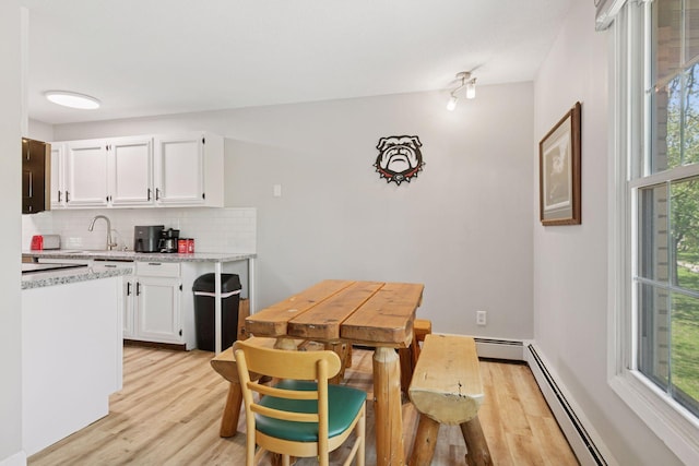 4430 Cedar Lake Rd S Unit 6, Saint Louis Park, MN 55416 - dining room featuring light wood-style flooring and baseboard heating