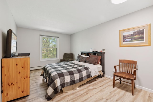 4430 Cedar Lake Rd S Unit 6, Saint Louis Park, MN 55416 - bedroom featuring baseboard heating, light wood-type flooring, and baseboards