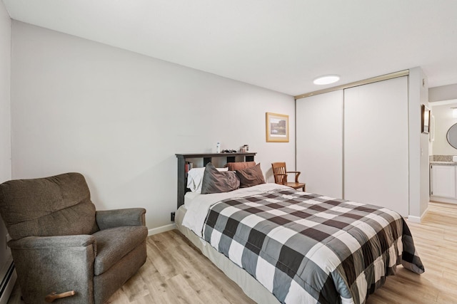 4430 Cedar Lake Rd S Unit 6, Saint Louis Park, MN 55416 - bedroom with light wood-type flooring, a baseboard heating unit, baseboards, and a closet
