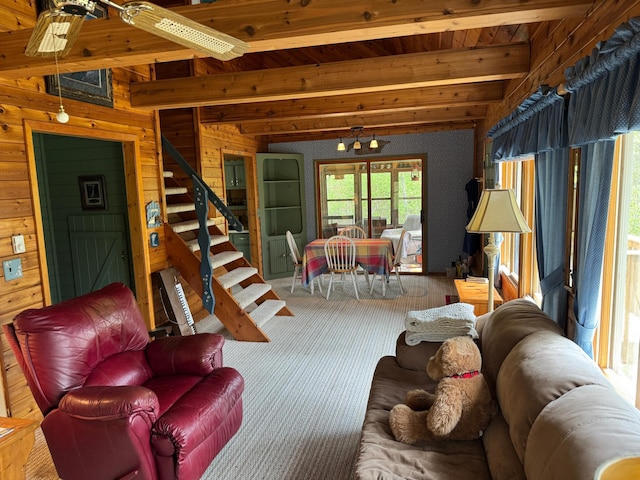 27721 Northwoods Dr, Laporte, MN 56461 - living room featuring wood walls, stairs, wood ceiling with exposed beams, and carpet floors