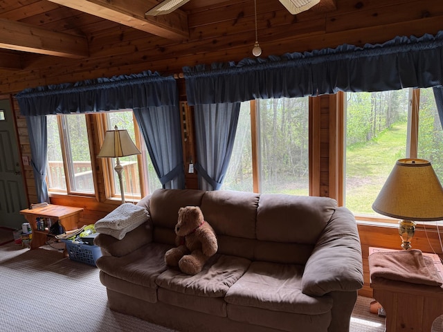 27721 Northwoods Dr, Laporte, MN 56461 - carpeted living room featuring wood walls and wooden ceiling with exposed beams